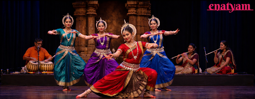 A group of female dancers perform Odissi classical dance form, an Indian classical dance known for its sculptural poses and temple origins.